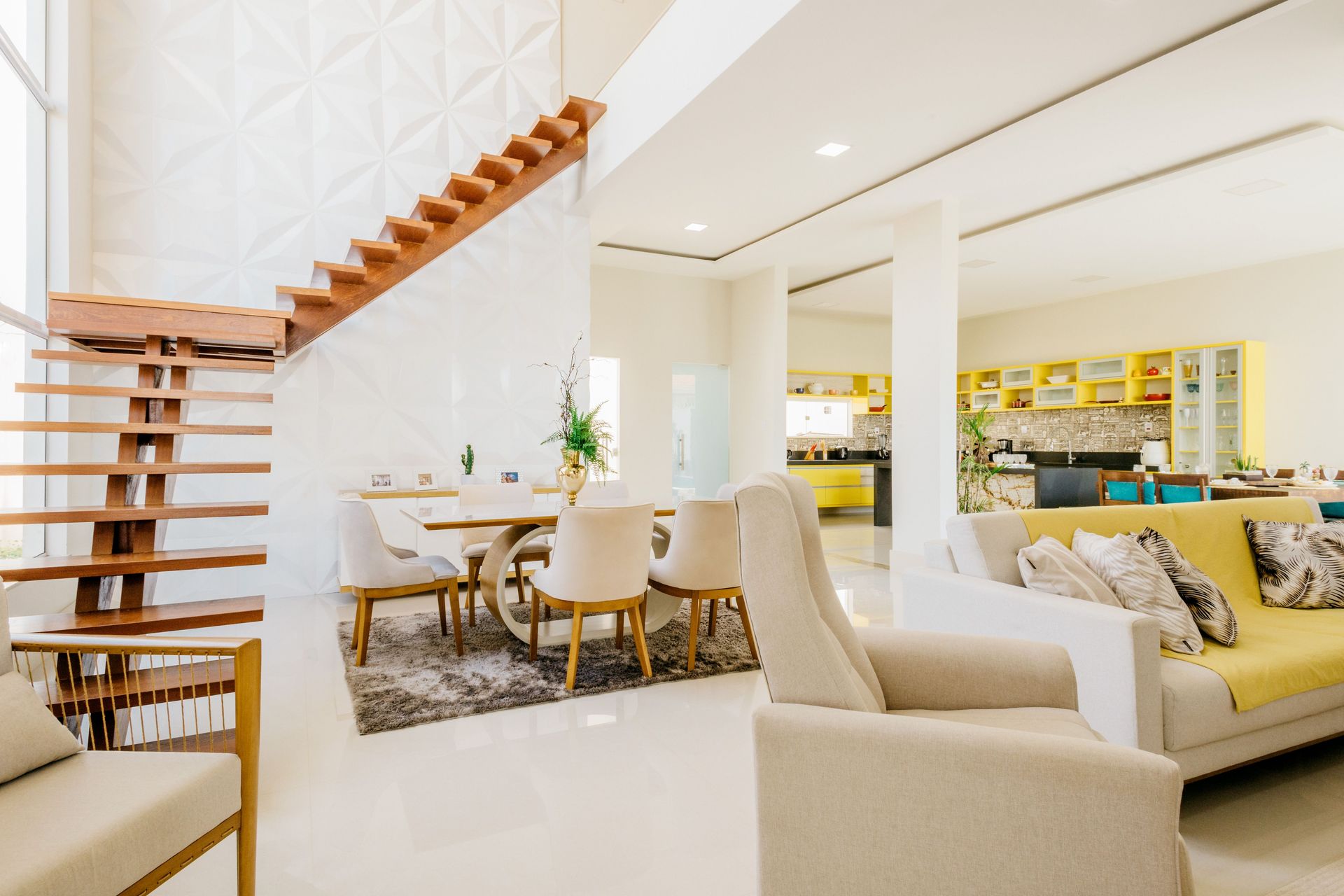 Spacious modern living room featuring elegant furniture and an open kitchen.